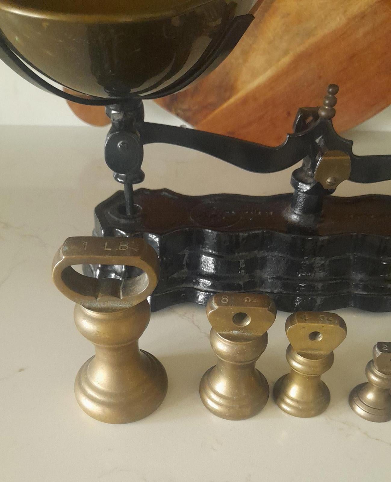 Vintage Black cast iron and brass Libra scales with 7 Bell weights.