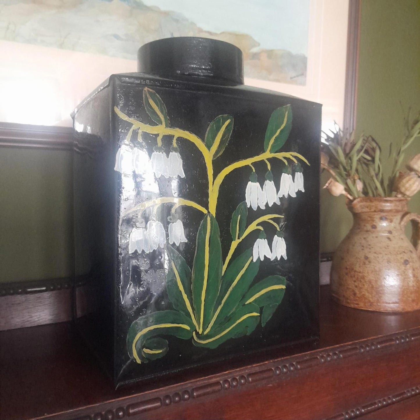 Large metal lidded tin with black lacquered finish hand painted flowers