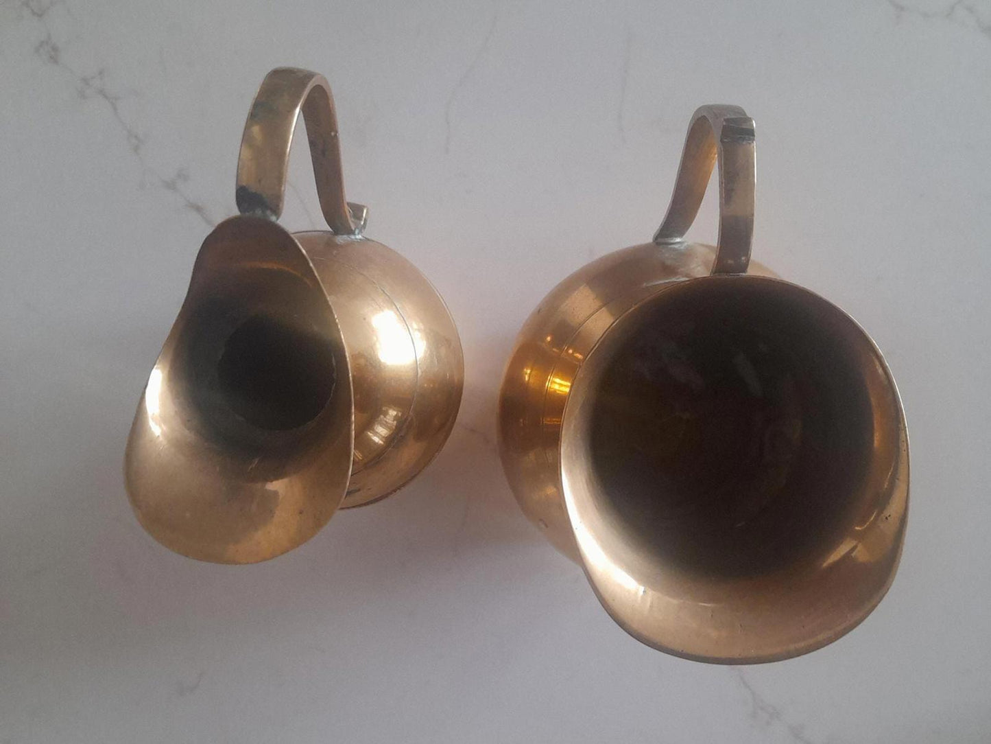 A pair of small brass jugs 5" tall