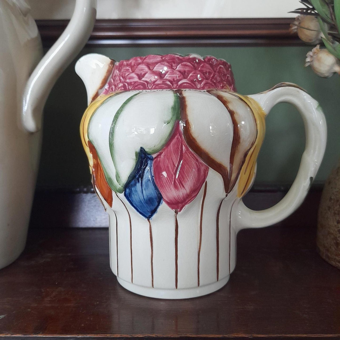 A pair of Art Deco style H. J Wood Ltd Burslem handpainted jugs.