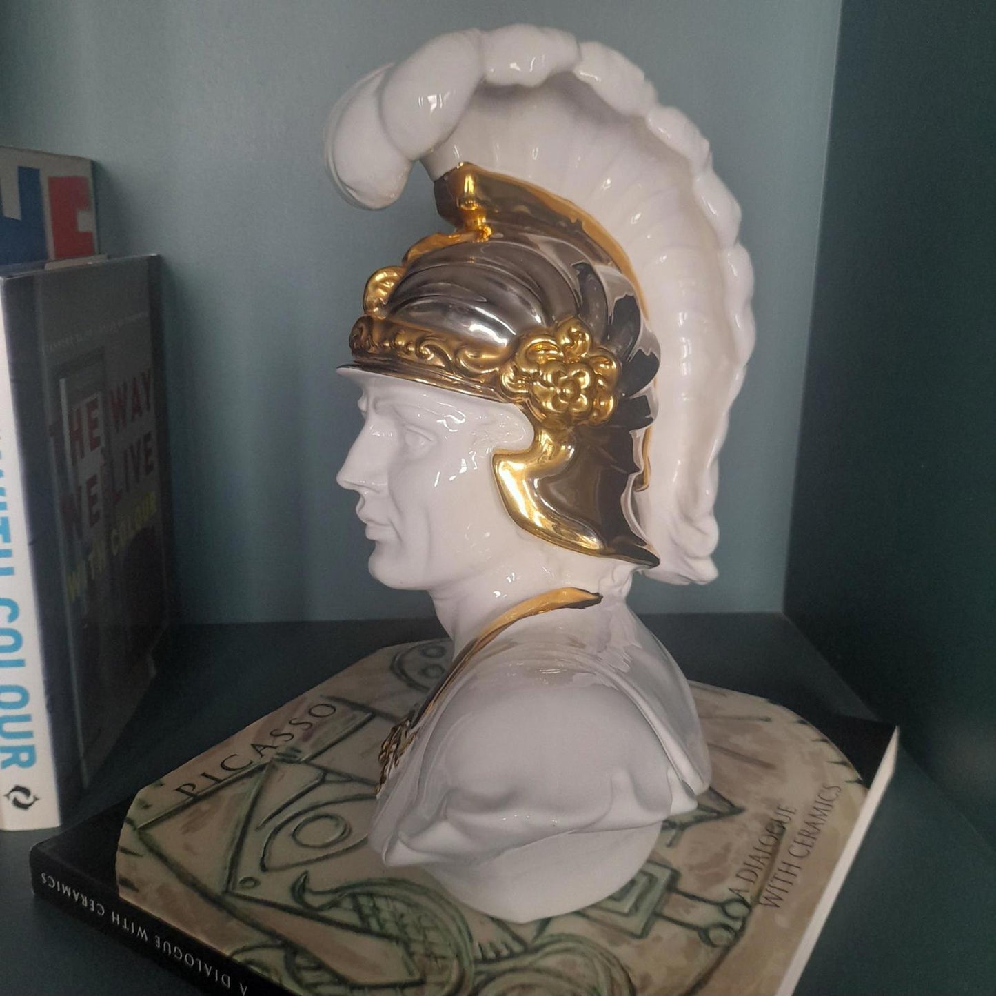 White ceramic bust of a gladiator with gold accents