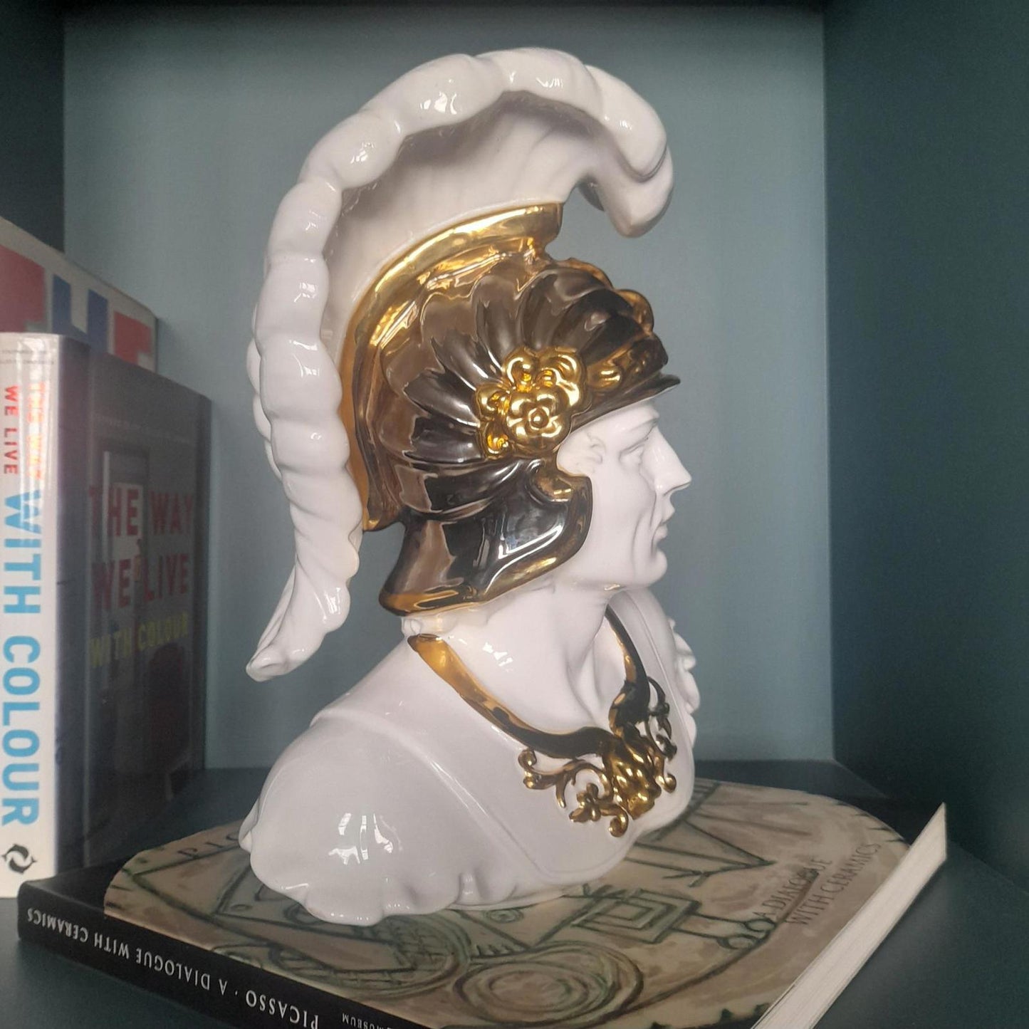 White ceramic bust of a gladiator with gold accents