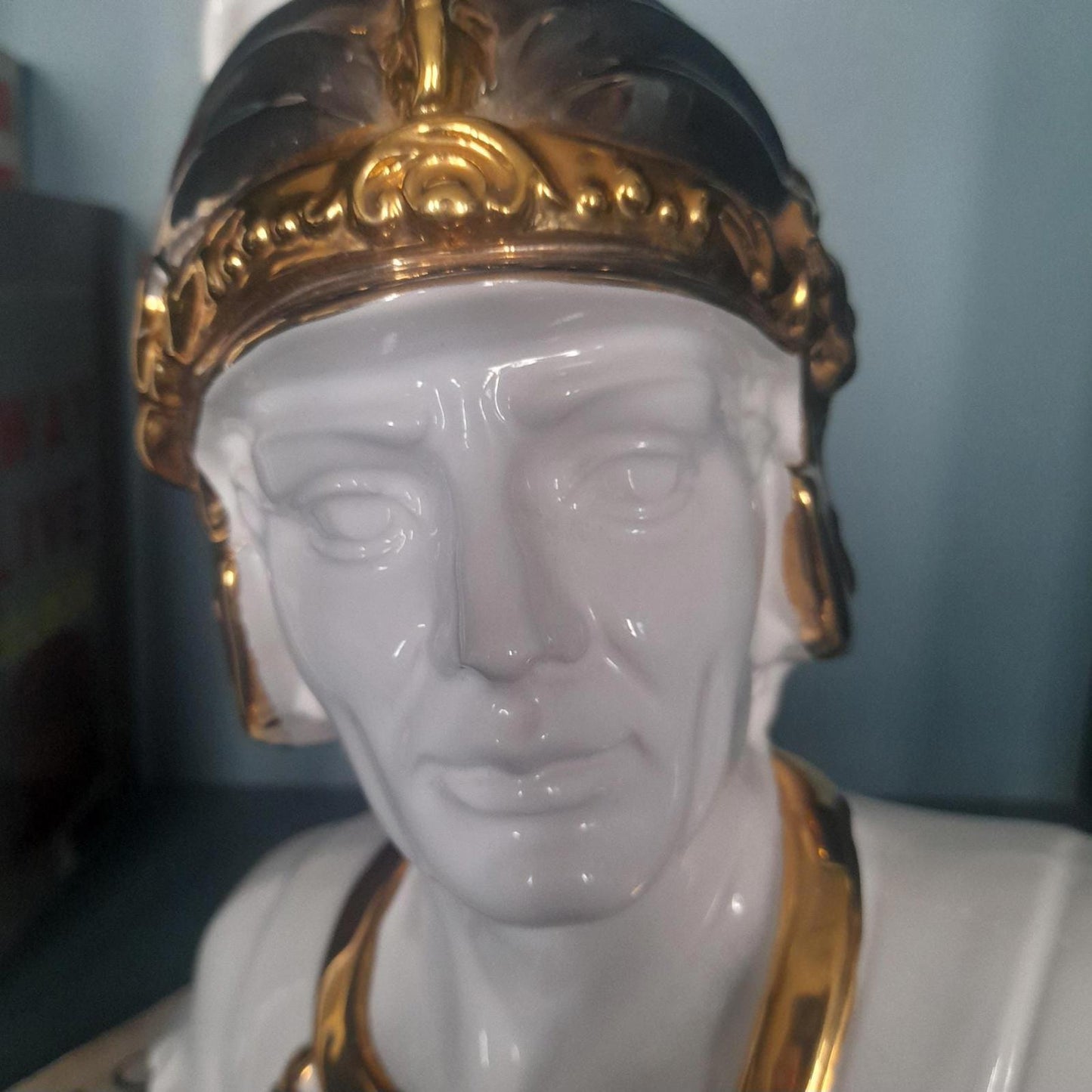 White ceramic bust of a gladiator with gold accents