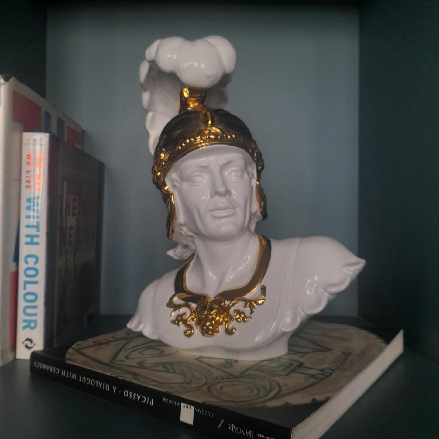 White ceramic bust of a gladiator with gold accents