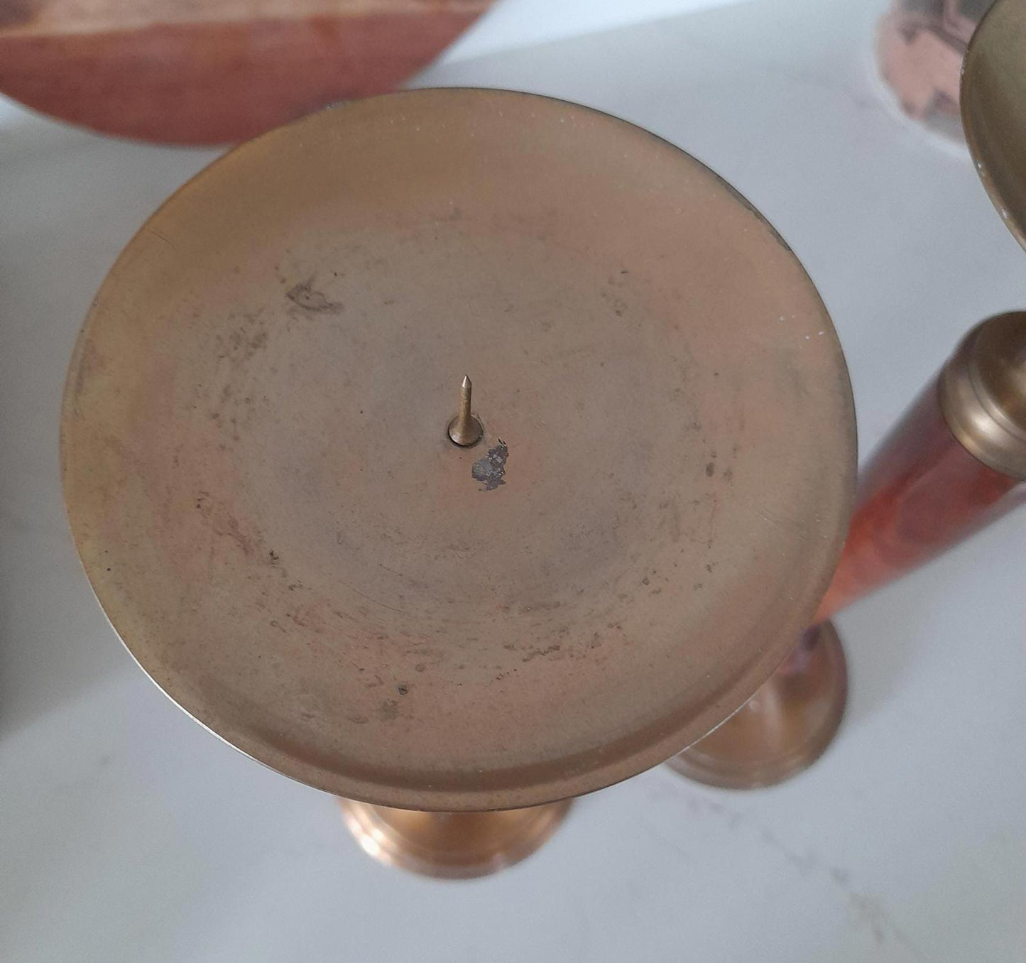 A pair of brass and dark wood tall candle holders