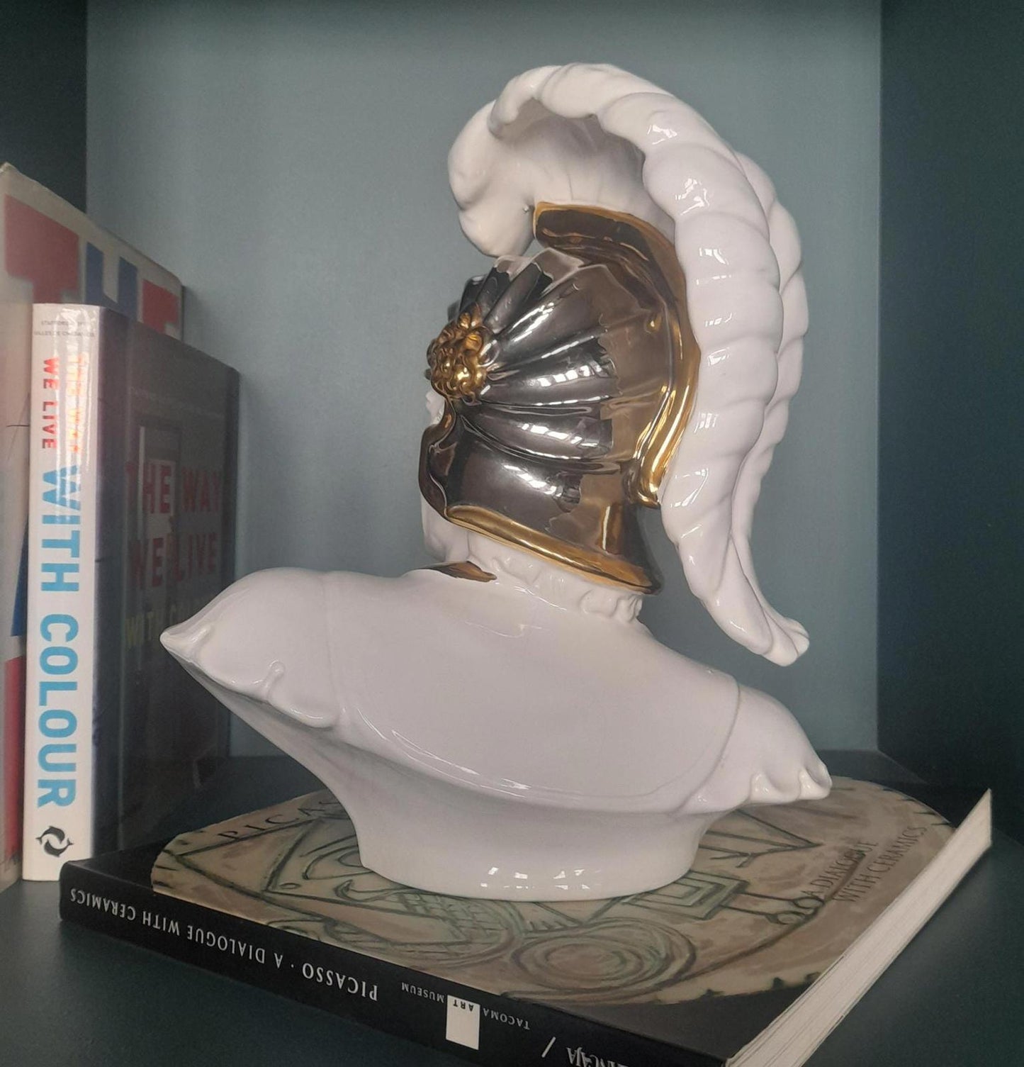White ceramic bust of a gladiator with gold accents