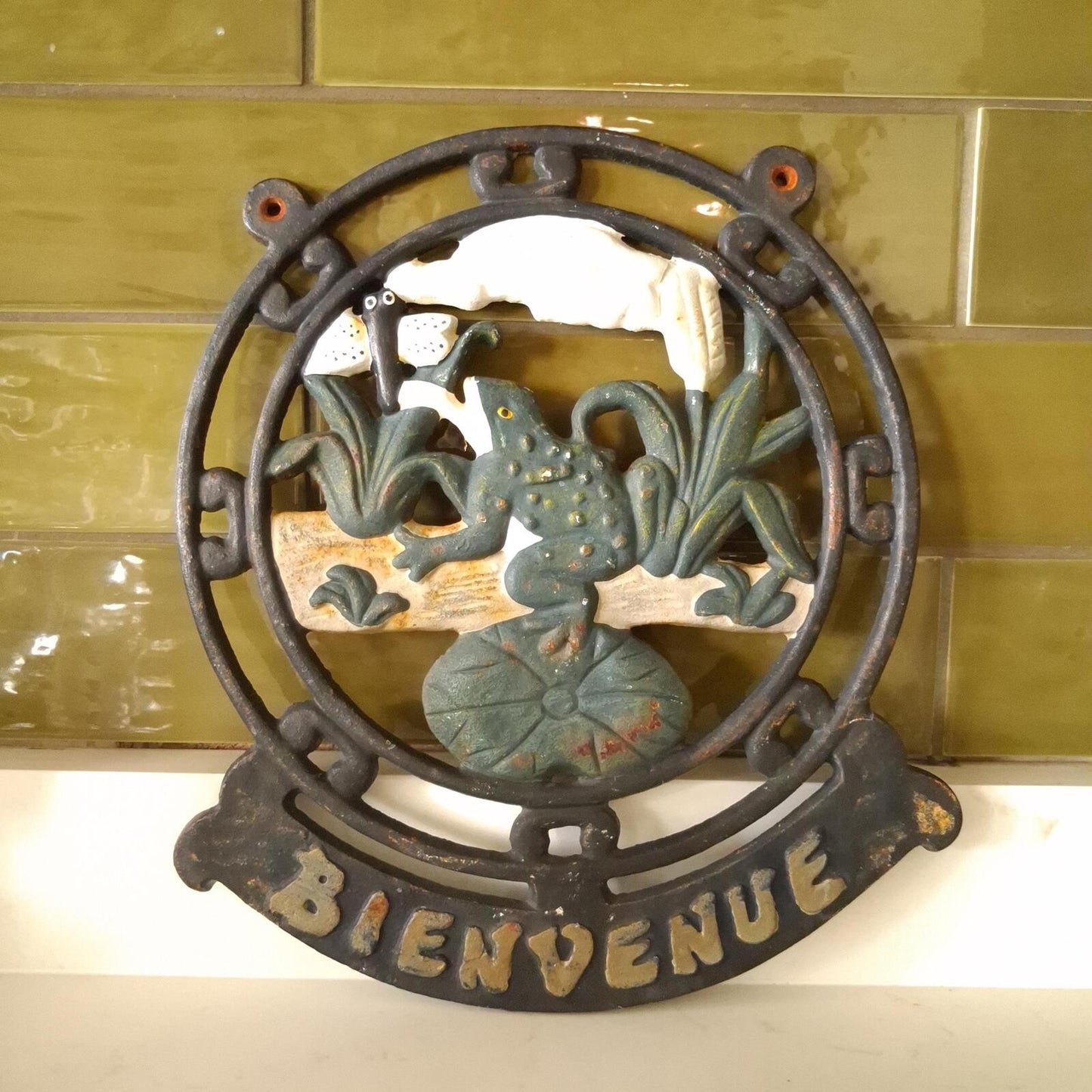 A vintage cast iron Bienvenue (Welcome) wall mountable sign.