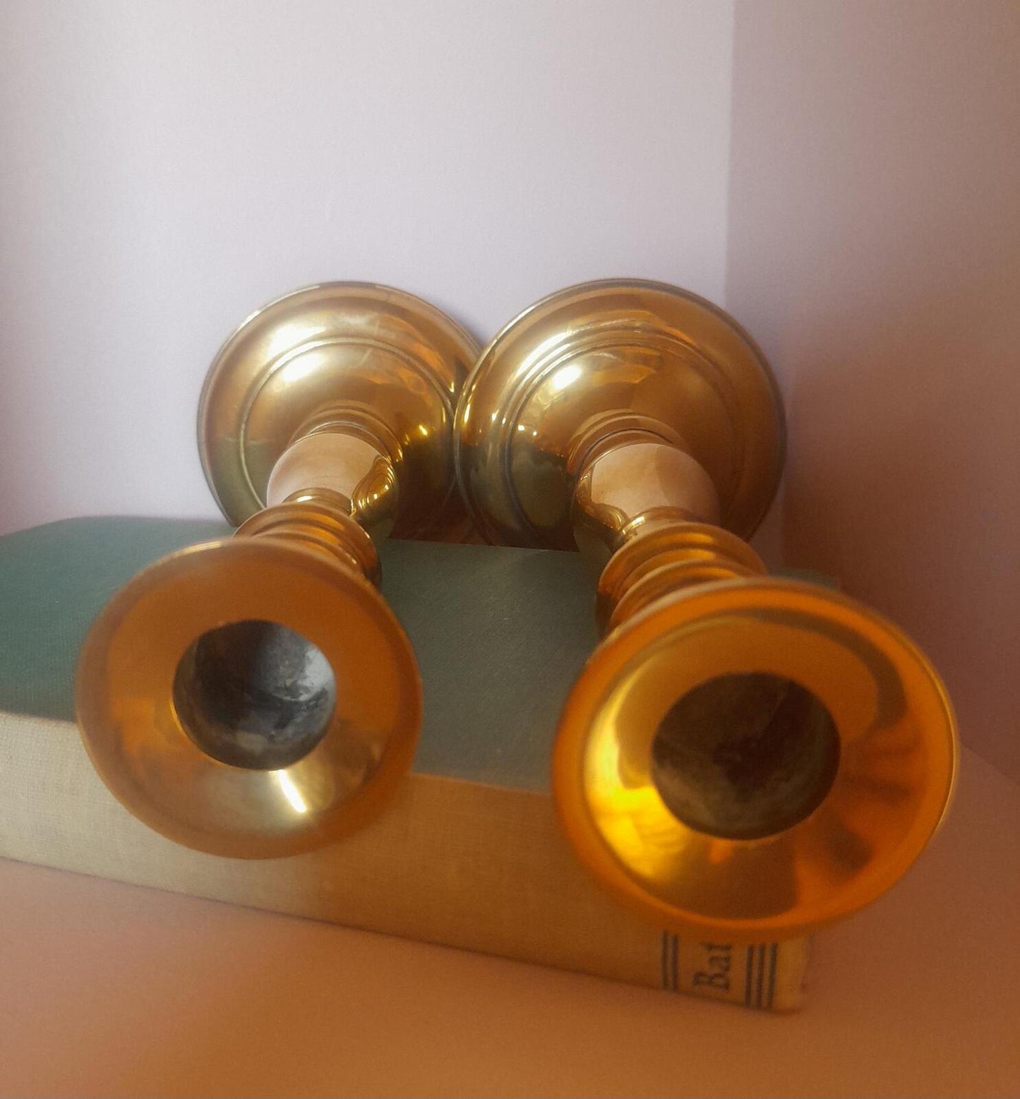 A pair of solid brass candlestick holders