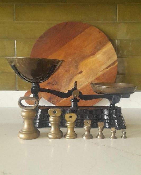 Vintage Black cast iron and brass Libra scales with 7 Bell weights.