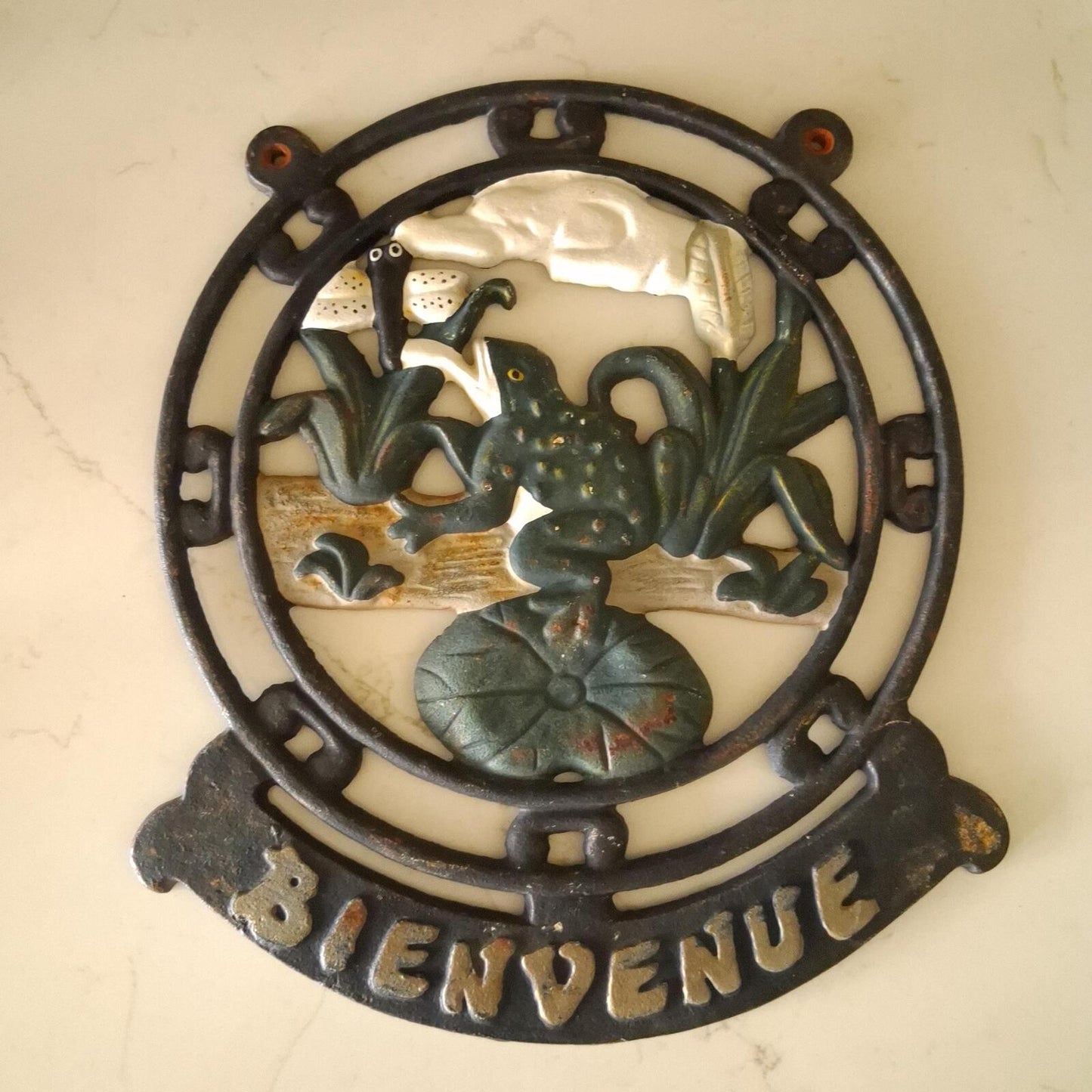 A vintage cast iron Bienvenue (Welcome) wall mountable sign.