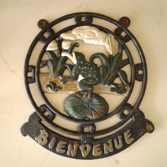 A vintage cast iron Bienvenue (Welcome) wall mountable sign.