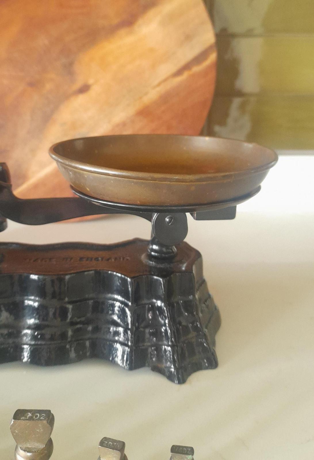 Vintage Black cast iron and brass Libra scales with 7 Bell weights.