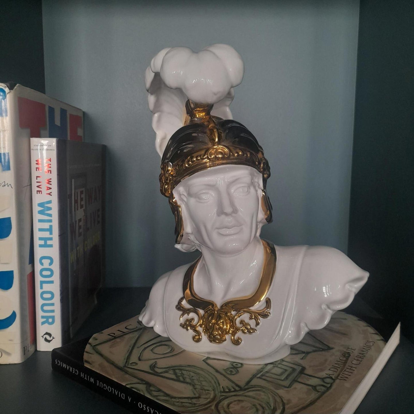 White ceramic bust of a gladiator with gold accents