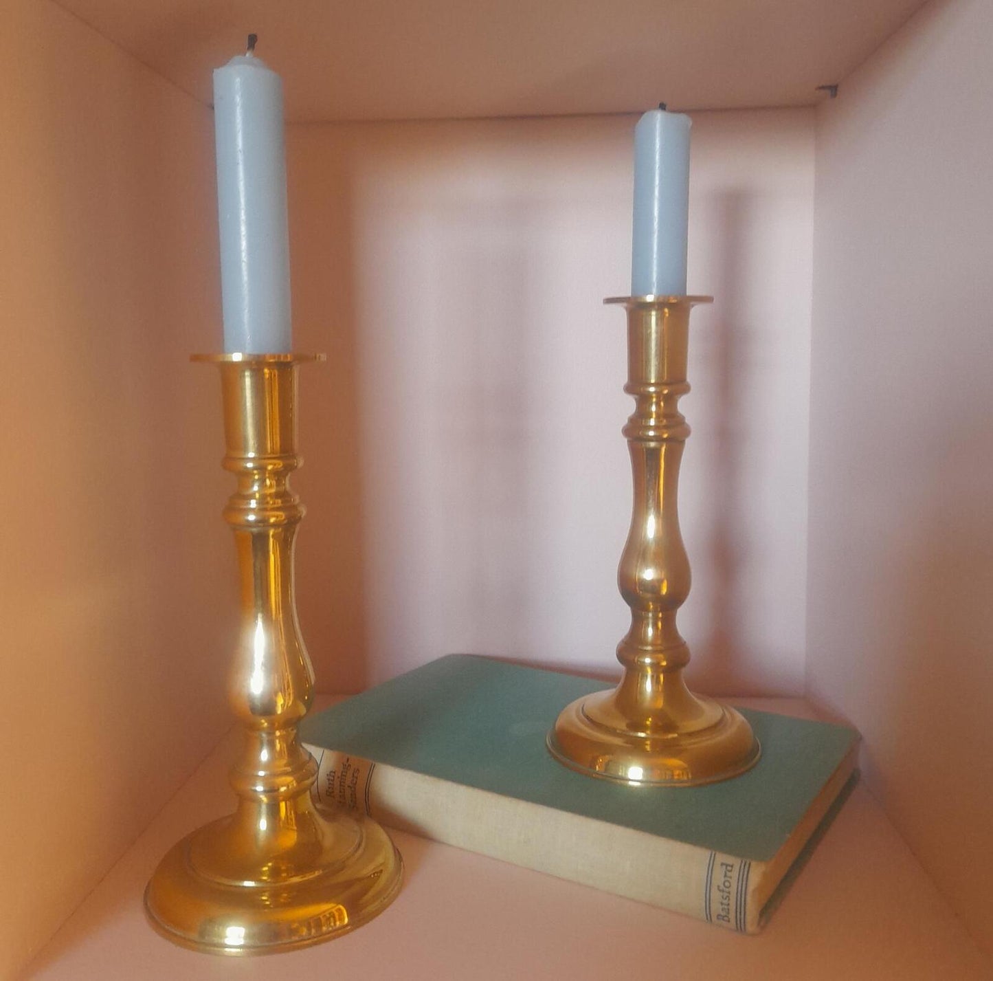 A pair of solid brass candlestick holders