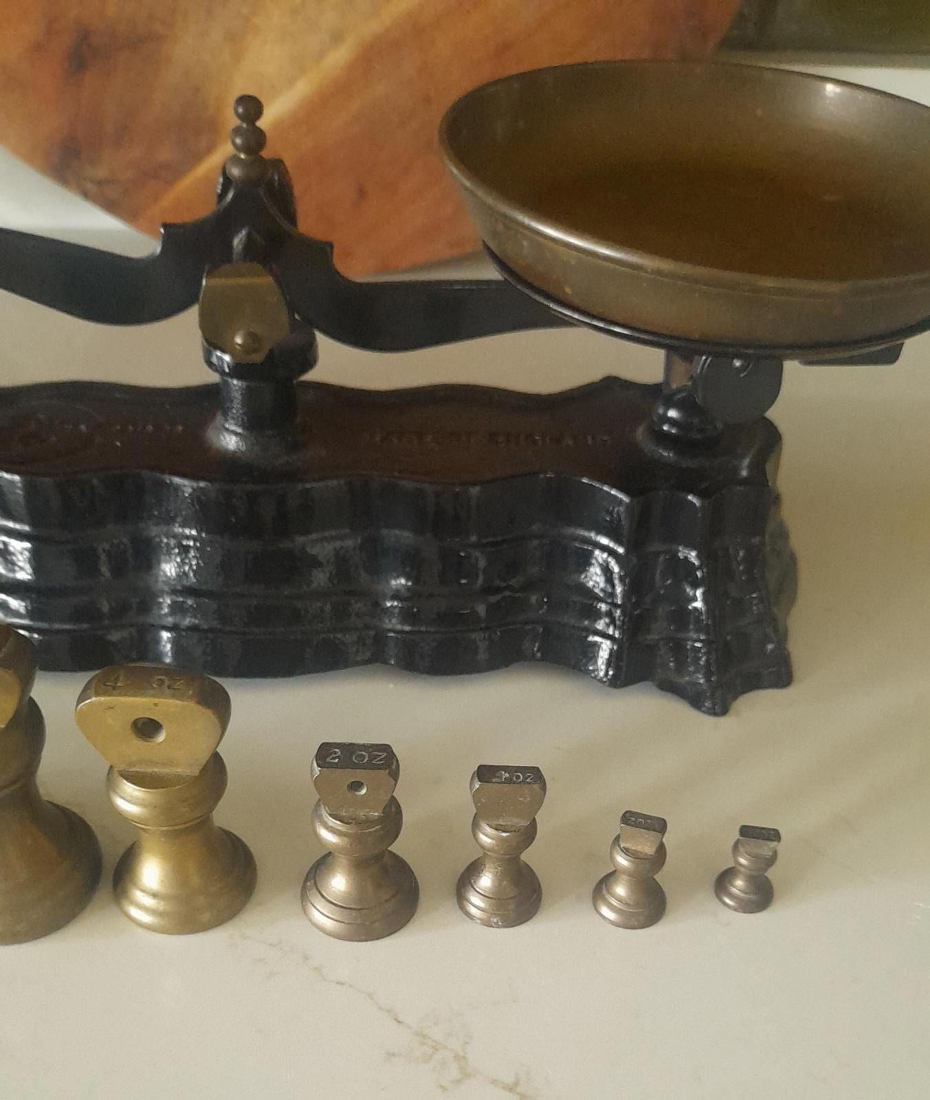 Vintage Black cast iron and brass Libra scales with 7 Bell weights.