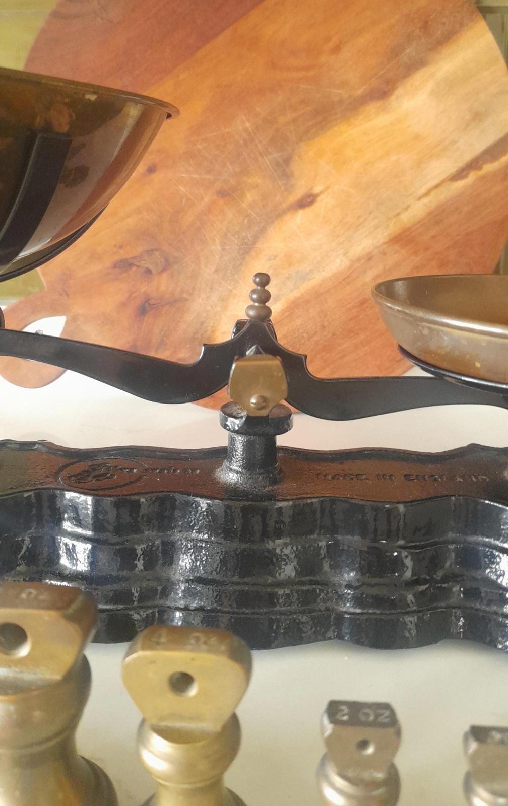 Vintage Black cast iron and brass Libra scales with 7 Bell weights.