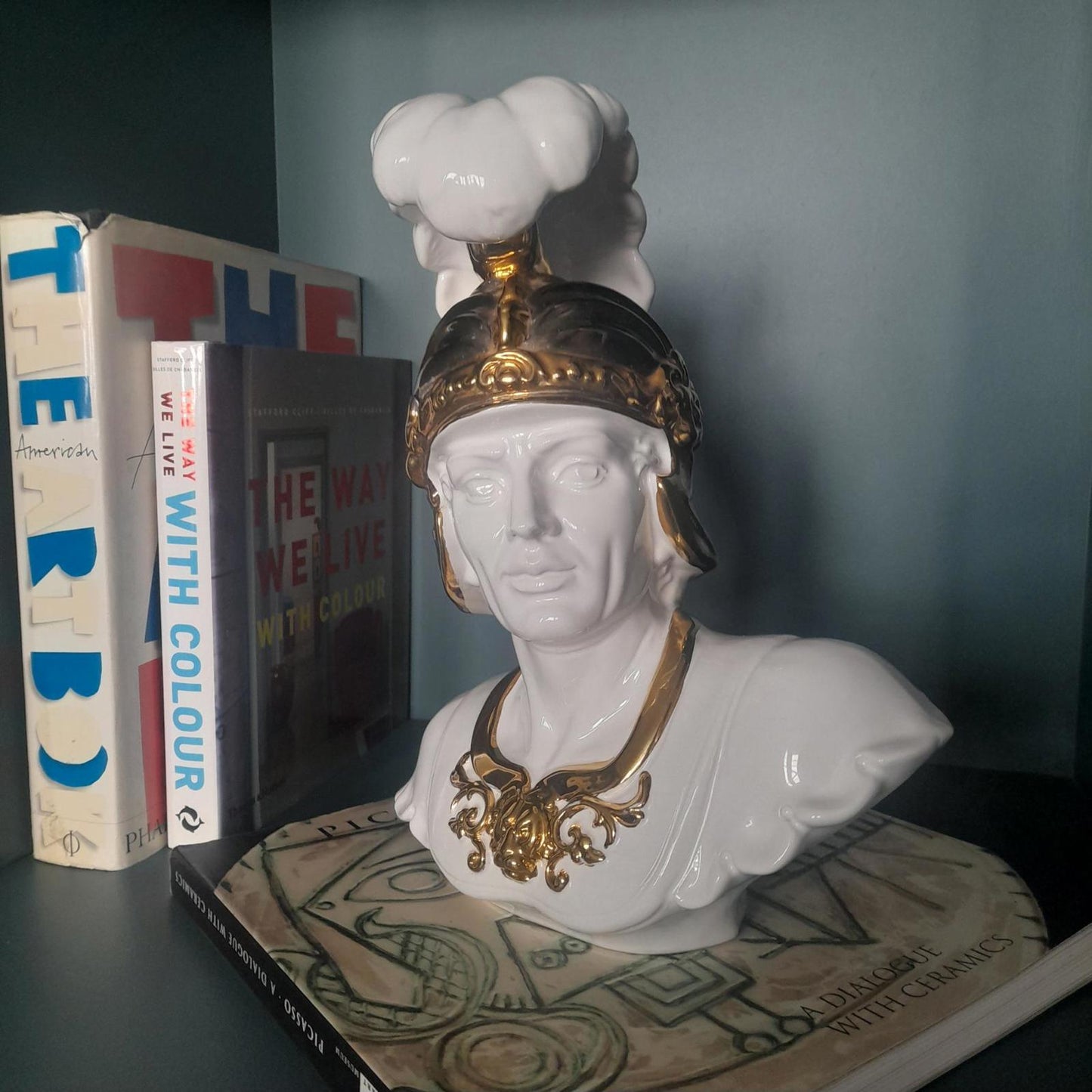 White ceramic bust of a gladiator with gold accents