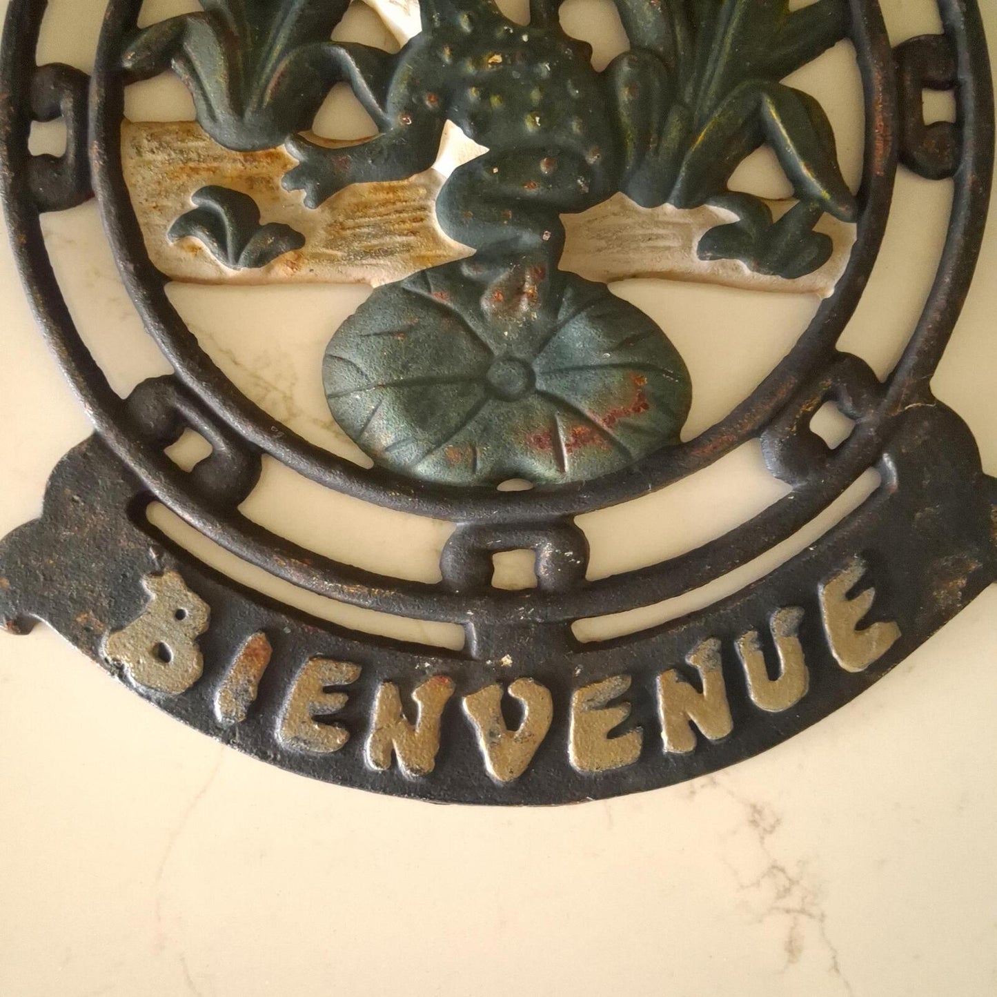 A vintage cast iron Bienvenue (Welcome) wall mountable sign.