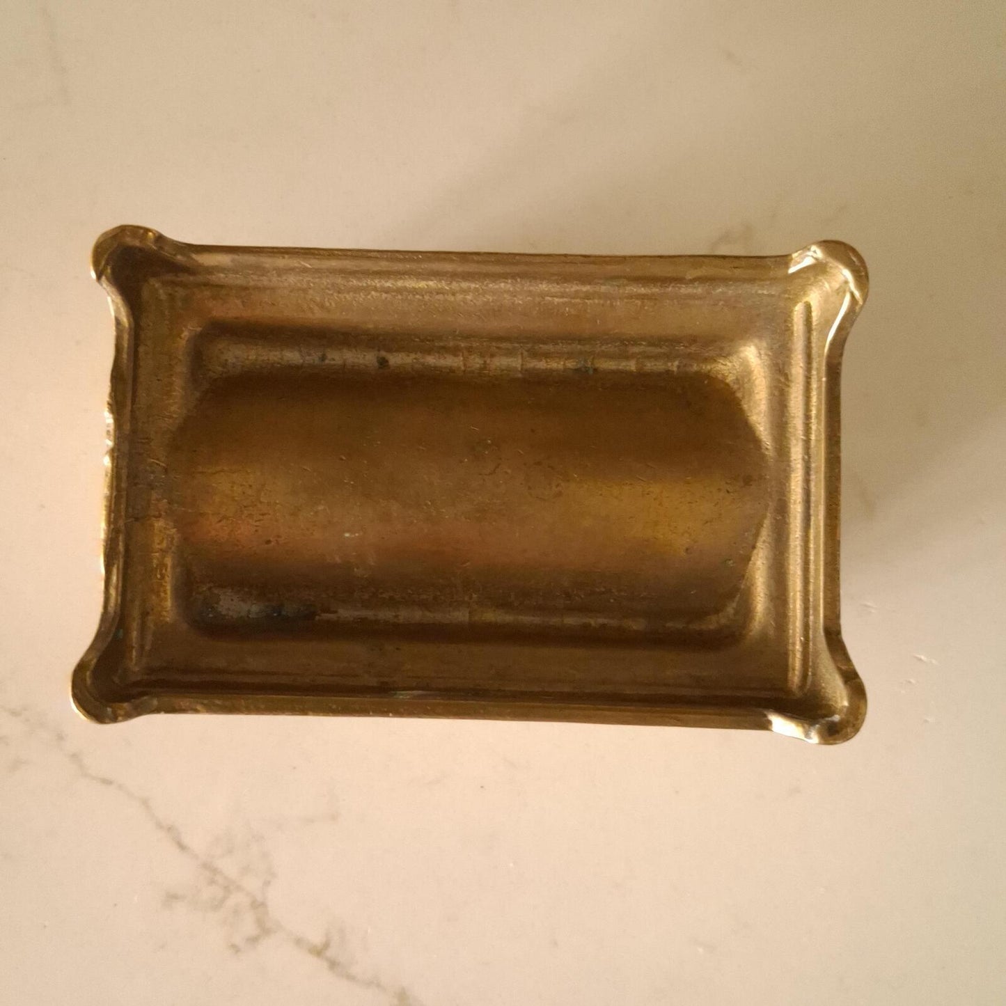 A brass sunflower design brass stamp holder