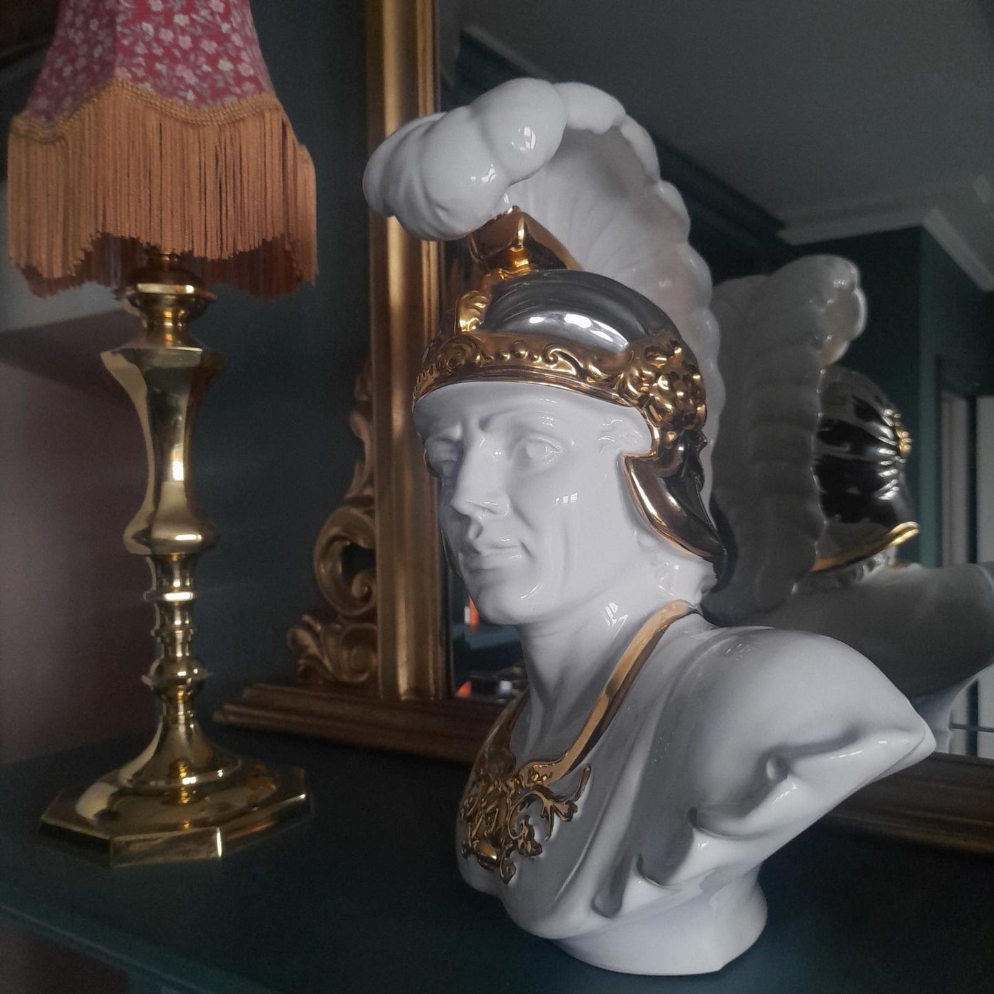 White ceramic bust of a gladiator with gold accents