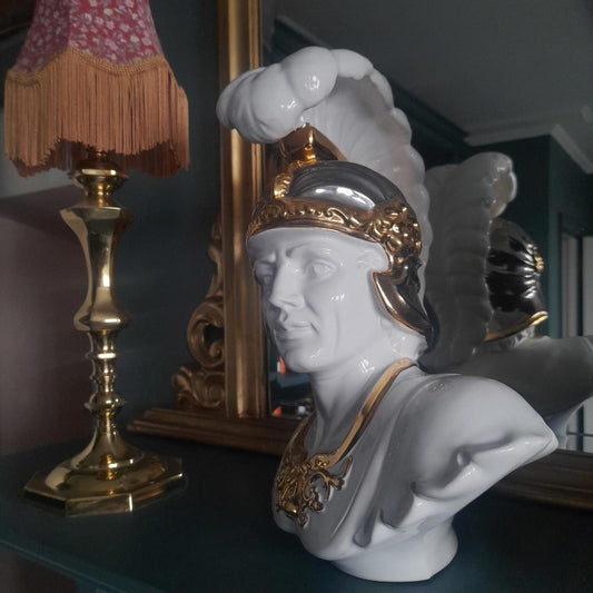 White ceramic bust of a gladiator with gold accents